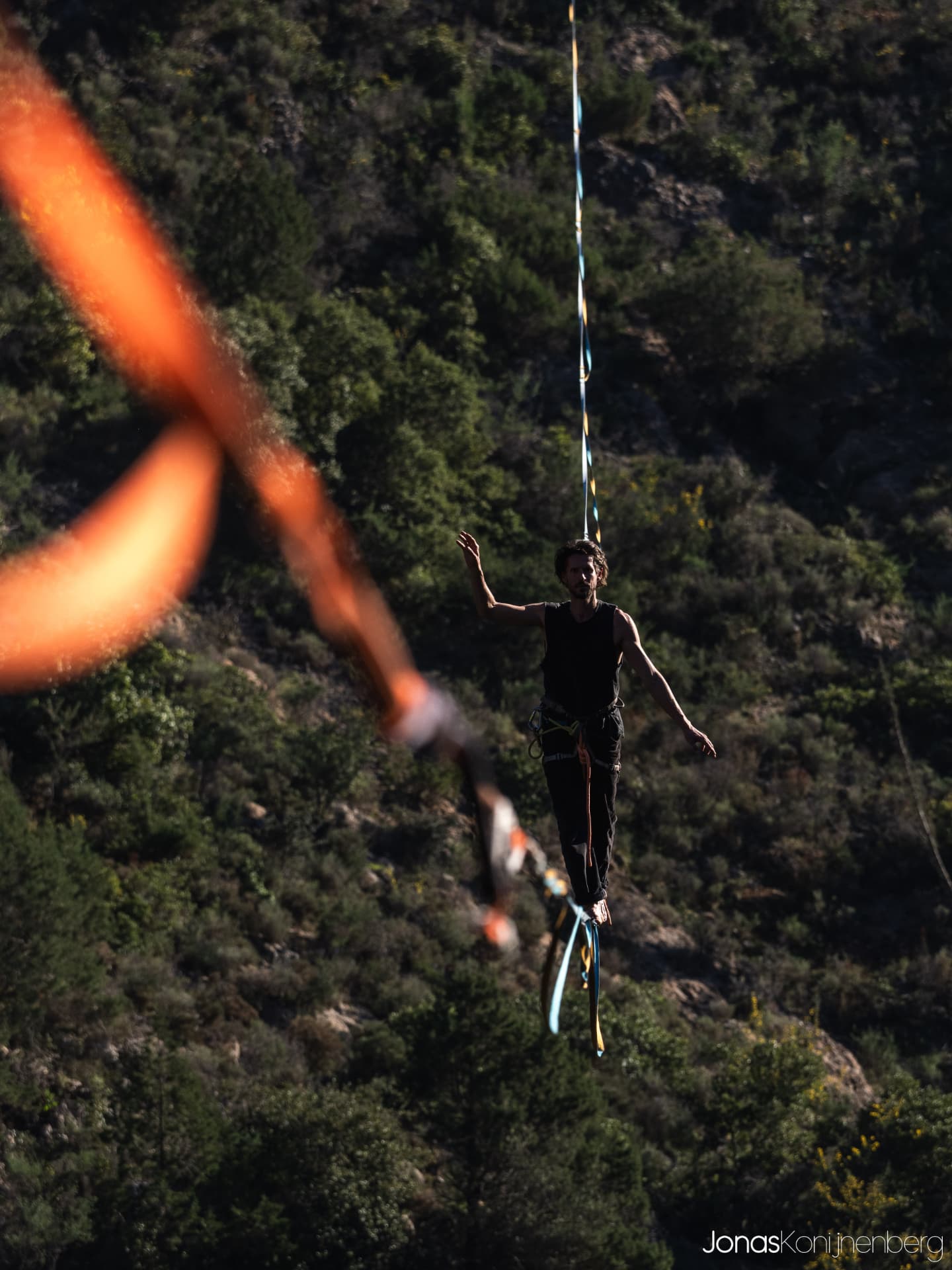 Tamas walking a highline in the mountains